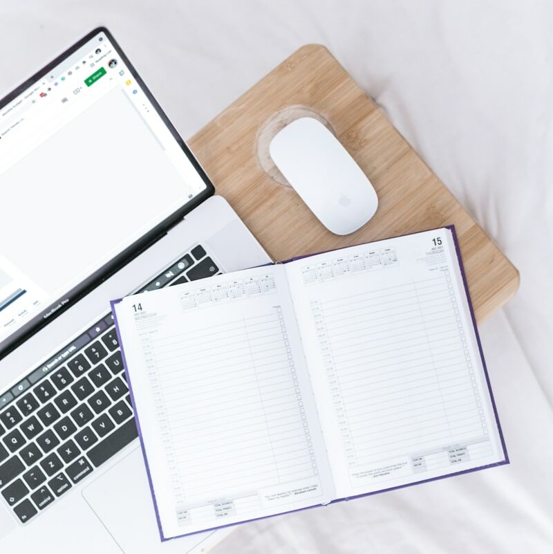 a laptop computer sitting on top of a wooden desk